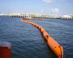 orange containment boom deployed in the sea